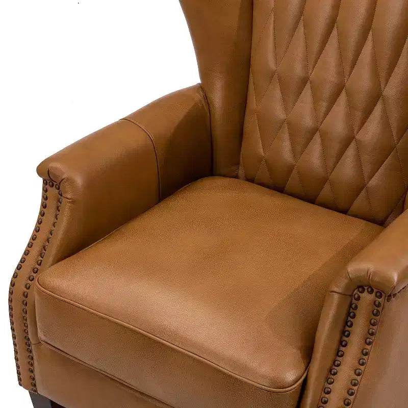 Fauteuil à oreilles en cuir véritable avec clous décoratifs et pieds fuselés en bois massif