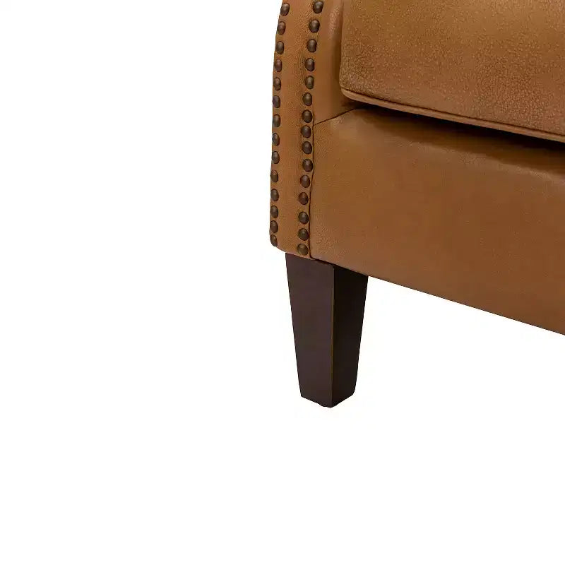 Fauteuil à oreilles en cuir véritable avec clous décoratifs et pieds fuselés en bois massif