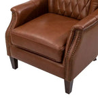 Fauteuil à oreilles en cuir véritable avec clous décoratifs et pieds fuselés en bois massif