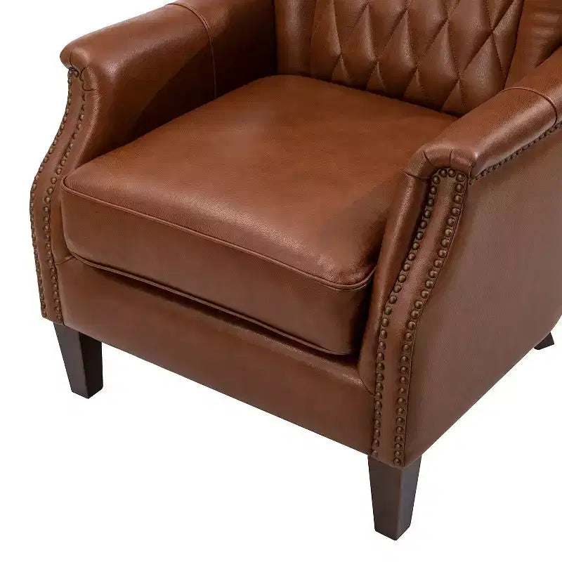 Fauteuil à oreilles en cuir véritable avec clous décoratifs et pieds fuselés en bois massif