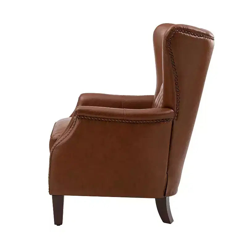 Fauteuil à oreilles en cuir véritable avec clous décoratifs et pieds fuselés en bois massif