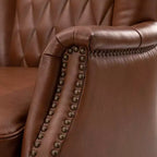 Fauteuil à oreilles en cuir véritable avec clous décoratifs et pieds fuselés en bois massif