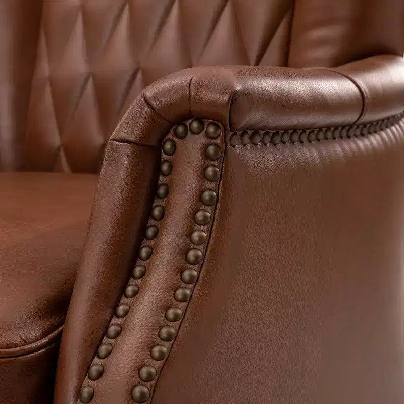 Fauteuil à oreilles en cuir véritable avec clous décoratifs et pieds fuselés en bois massif